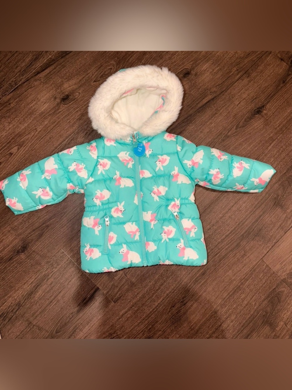 Cozy turquoise puffer coat with adorable pink bunny print and plush faux-fur